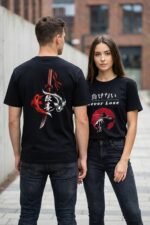 Couple walking outdoors wearing matching black cotton t-shirts featuring a red sun graphic, Japanese calligraphy, and the message Never Lose