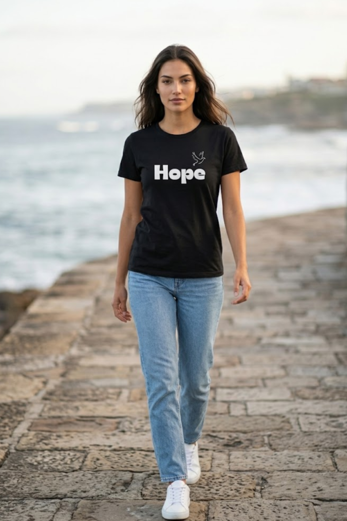 Main product photo for the HOPE t-shirt. This pure cotton black tee showcases a simple yet profound typography design, perfect for spreading optimism and resilience every day.