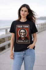 Woman wearing a black "Your Turn Wanna Play" Jigsaw graphic tee – horror-inspired black t shirt mens outfit lifestyle shot