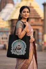Lifestyle photography of a woman carrying the Lord Jagannath Black Cotton Tote Bag – spiritual and ethnic fashion accessory