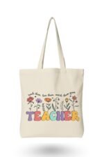 Natural cream canvas tote bag with colorful floral "TEACHER" typography – perfect inspirational gift to pair with a motivational t-shirt
