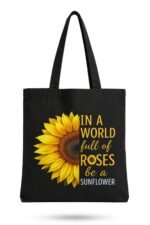 Black canvas tote bag with a vibrant sunflower graphic and "Be A Sunflower" quote – motivational canvas tote bag for daily inspiration