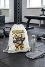The BINDAS anime graphic drawstring gym bag displayed standing upright on a studio floor next to a water bottle.