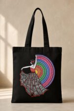 Black heavyweight canvas tote bag featuring an artistic traditional Indian dancer with colorful concentric mandala fan print and secure zipper closure.