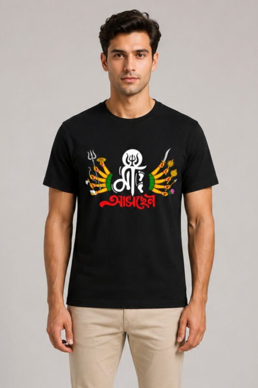 Male model wearing regular fit jet black graphic t-shirt featuring Bengali typography Maa Aaschen with Maa Durga ten hands illustration for Durga Puja festival.