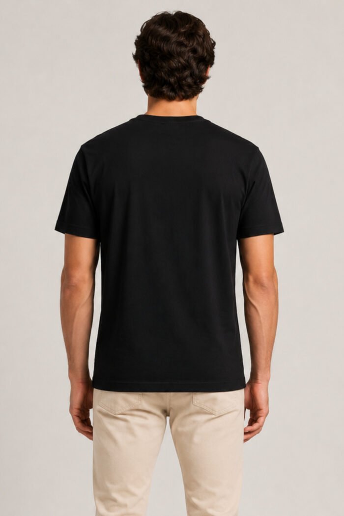 Back view of male model wearing solid jet black regular fit cotton crewneck t-shirt.