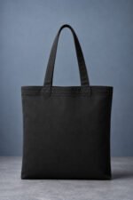 Plain back view of cute chibi white kitten black canvas tote bag with reinforced handles